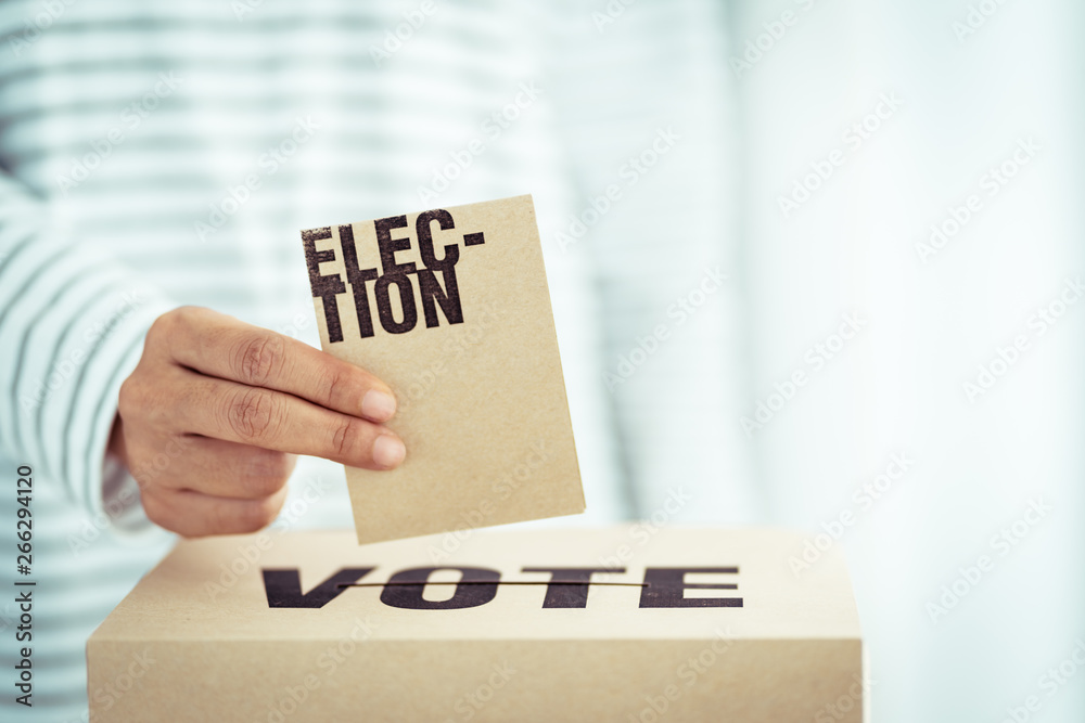brown paper insert in vote box, bright future of democracy concept brown paper insert in vote box, bright future of democracy concept