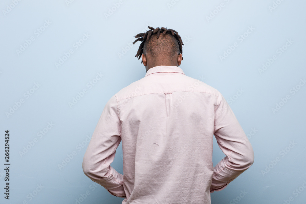 Young business african black man from behind, looking back.