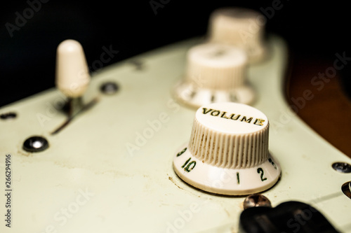 Details of electric guitar relic with macro dark background