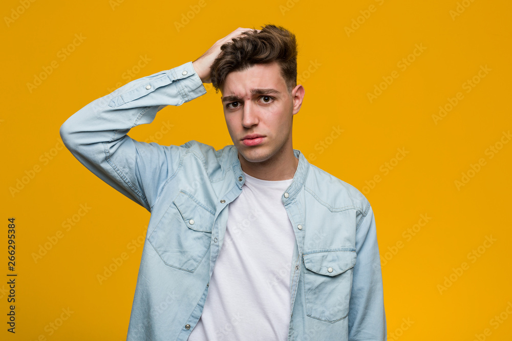 Young handsome student wearing a denim shirt being shocked, he has remembered important meeting. Young handsome student wearing a denim shirt being shocked, he has remembered important meeting.