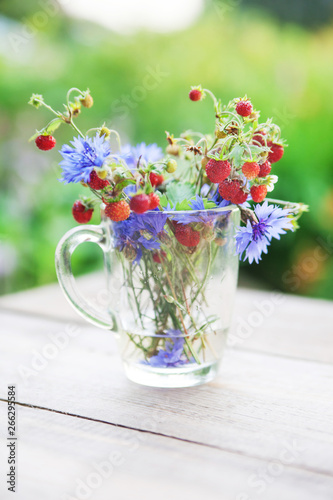 Fototapeta Naklejka Na Ścianę i Meble -  Bouquet from wild strawberry and flowers. Healthy natural food. Ecological clean products
