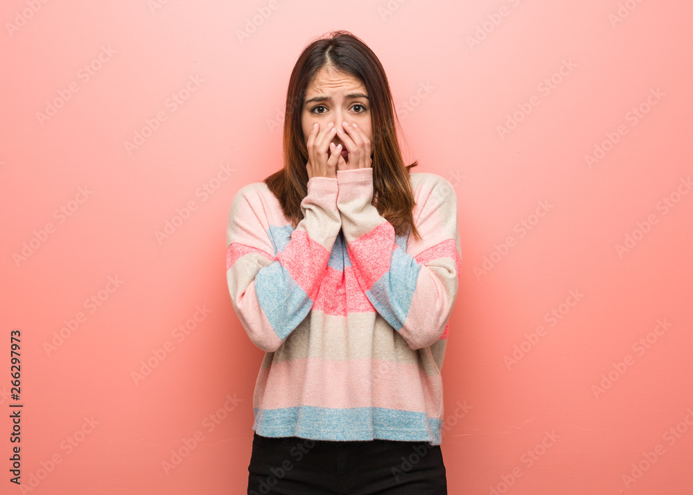 Young cute woman very scared and afraid hidden Young cute woman very scared and afraid hidden