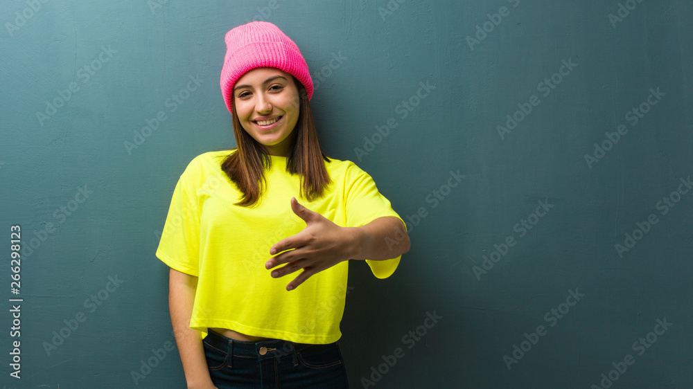 Young modern woman reaching out to greet someone Young modern woman reaching out to greet someone