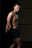 Handsome Bodybuilder Making Side Triceps Pose
