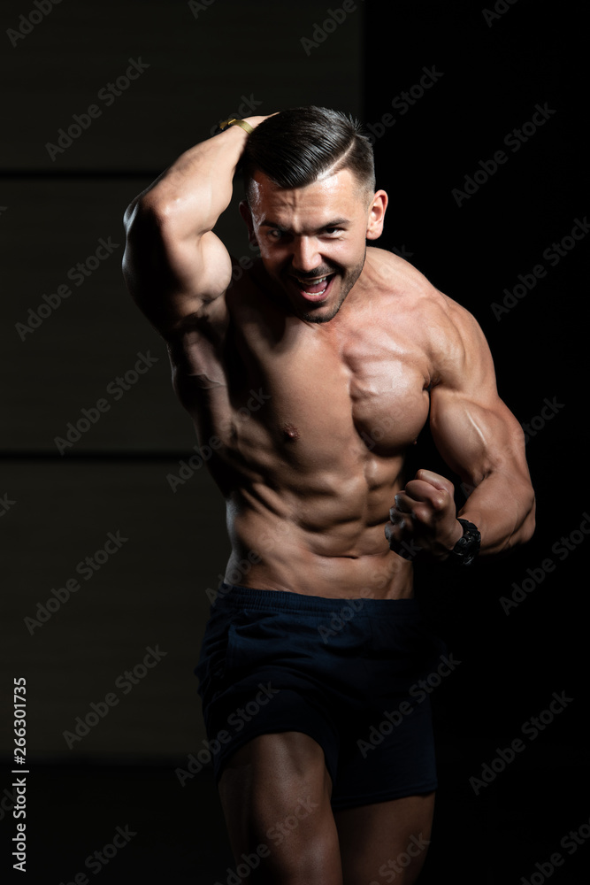 Handsome Body Builder Making Side Chest Pose