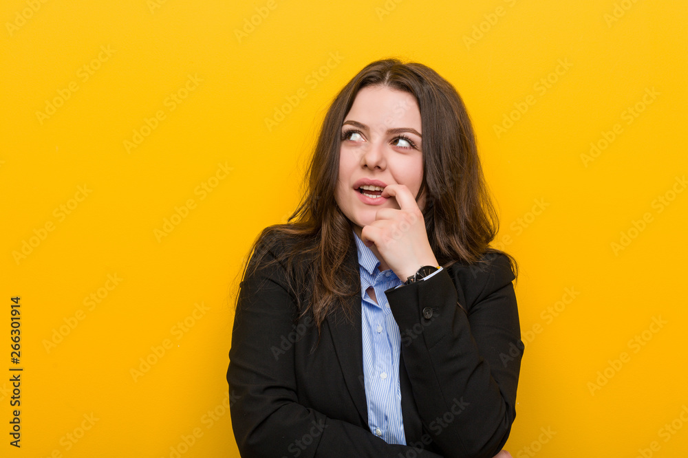 Young plus size caucasian business woman relaxed thinking about something looking at a copy space. Young plus size caucasian business woman relaxed thinking about something looking at a copy space.