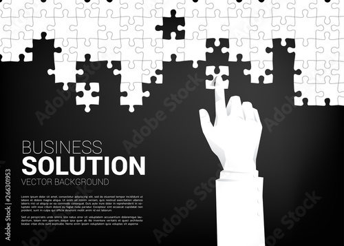 close up businessman hand put jigsaw piece to fit together. business concept of solution and business matching.