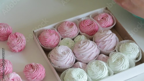 Wallpaper Mural Woman puts marshmallow in a gift box. Marshmallow different colors. Shot close up.. Torontodigital.ca