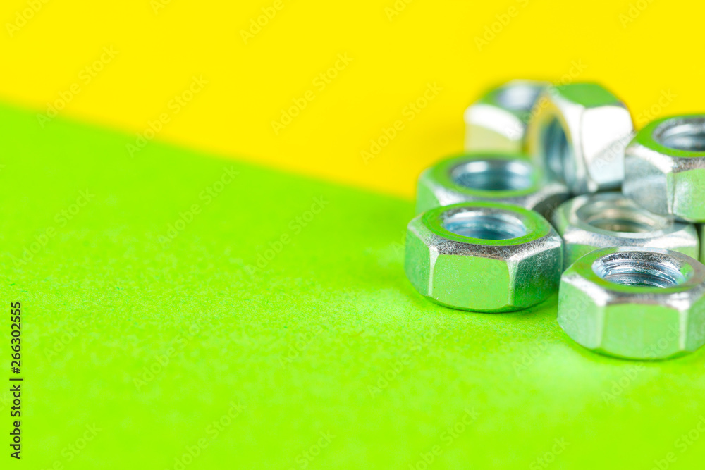 Tools. Nuts on green background close up Tools. Nuts on green background close up