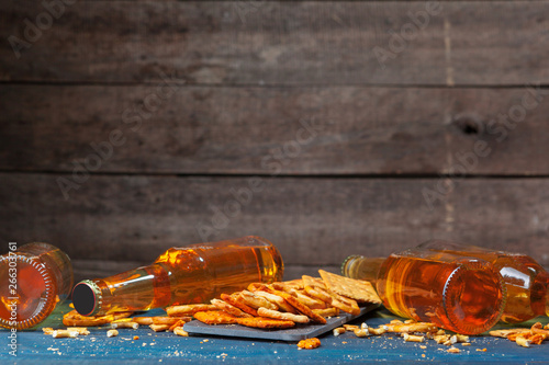 A selection of beer and snacks on wooden background