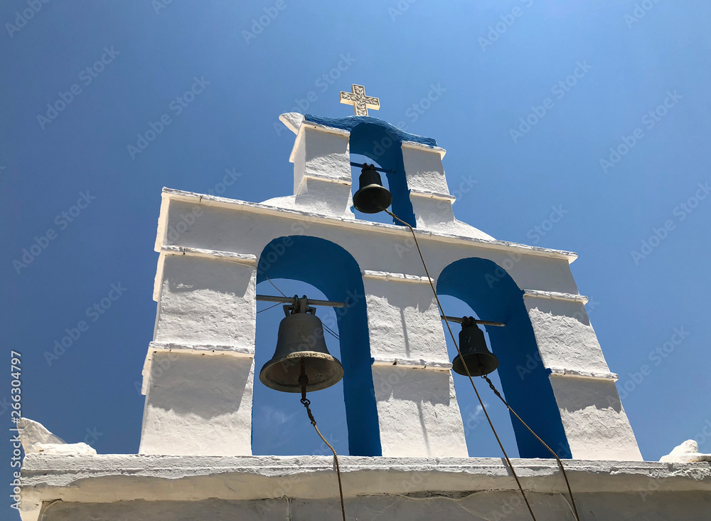 Detail of a tower bell in a Christian Orthodox monastery in a Greek island with blue sky.