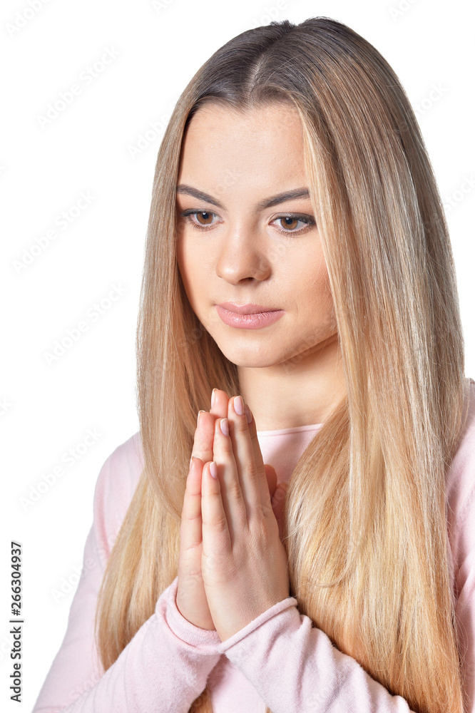 Close up portrait of beautiful blonde woman praying on white background Close up portrait of beautiful blonde woman praying on white background
