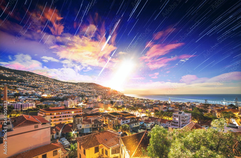 Beautiful long exposure stacked view of the skyline cityscape of the city Funchal on the island Madeira at sunrise in summer with startrails