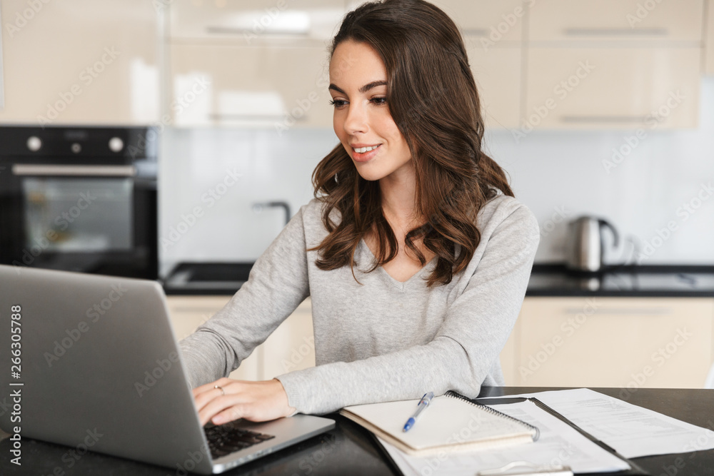 Attractive young woman working on laptop computer Attractive young woman working on laptop computer