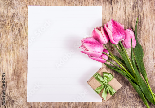 Gift box and tulips. Empty sheet of paper and flowers. Pink tulips