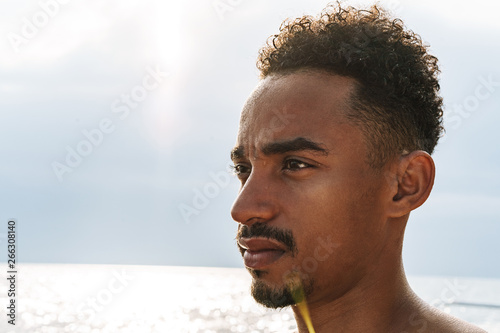 Young african sports man outdoors at the beach sea.