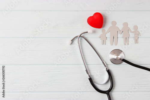 stethoscope and heart on a colored background top view. Family medicine