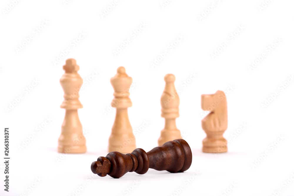 Wooden chess pieces in duel. White king, lady and shooter with horse. The defeated black king surrenders to the team. Isolated on white background Wooden chess pieces in duel. White king, lady and shooter with horse. The defeated black king surrenders to the team. Isolated on white background