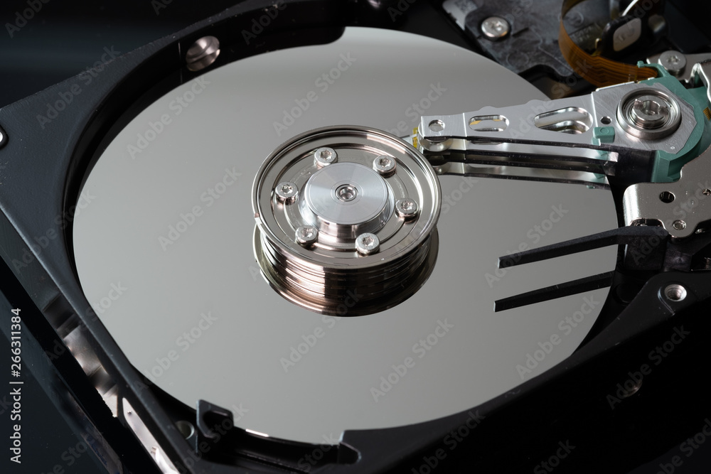 Hard drive from the computer hdd with mirror effect. Close-up, macro, on a black background. And repair tools. Hard drive from the computer hdd with mirror effect. Close-up, macro, on a black background. And repair tools.
