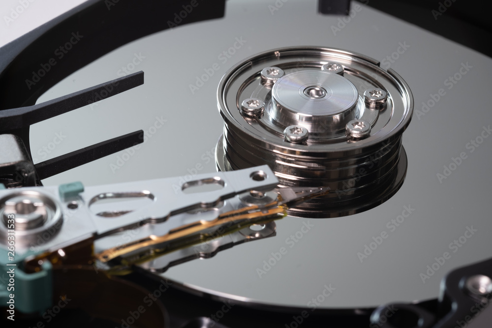 Hard drive from the computer hdd with mirror effect. Close-up, macro, on a white background. And repair tools. Hard drive from the computer hdd with mirror effect. Close-up, macro, on a white background. And repair tools.