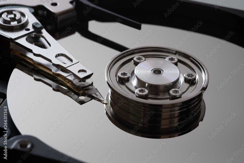 Hard drive from the computer hdd with mirror effect. Close-up, macro, on a white background. And repair tools. Hard drive from the computer hdd with mirror effect. Close-up, macro, on a white background. And repair tools.