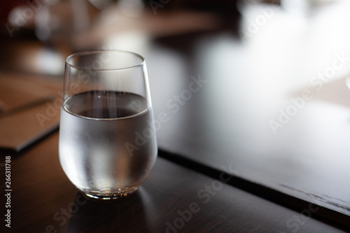 A glass of cold mineral water on the dining table in the restaurant .