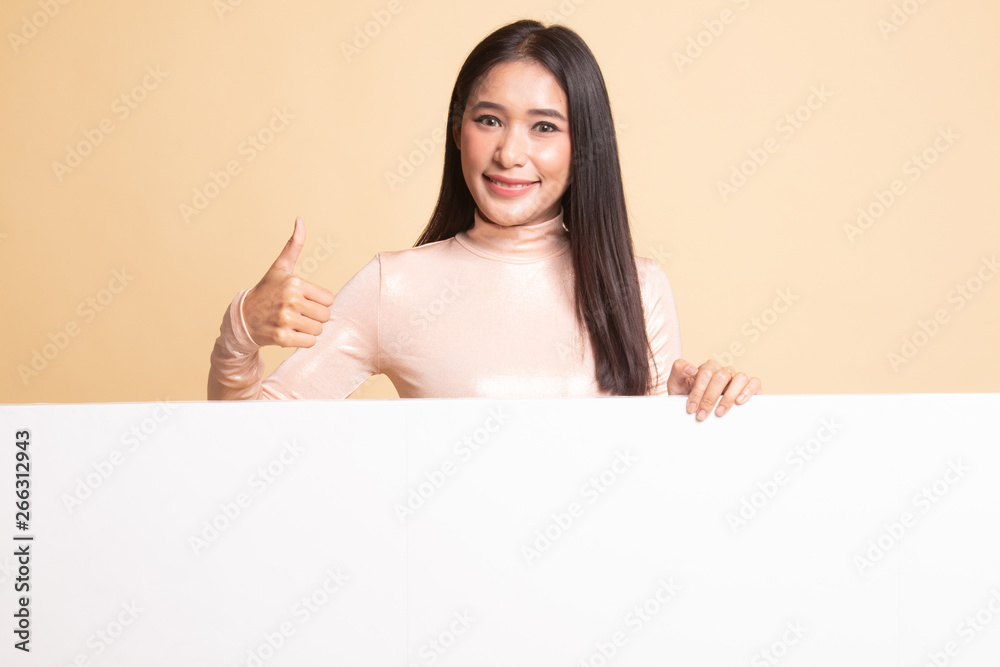 Young Asian woman show thumbs up with blank sign. Young Asian woman show thumbs up with blank sign.