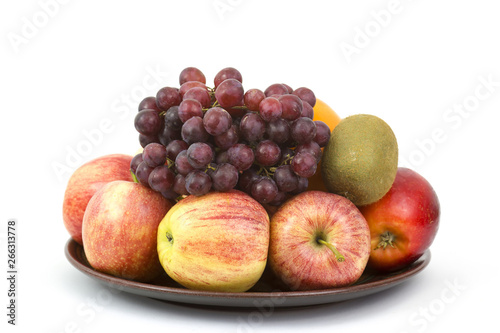 fresh fruits on a plate on white background
