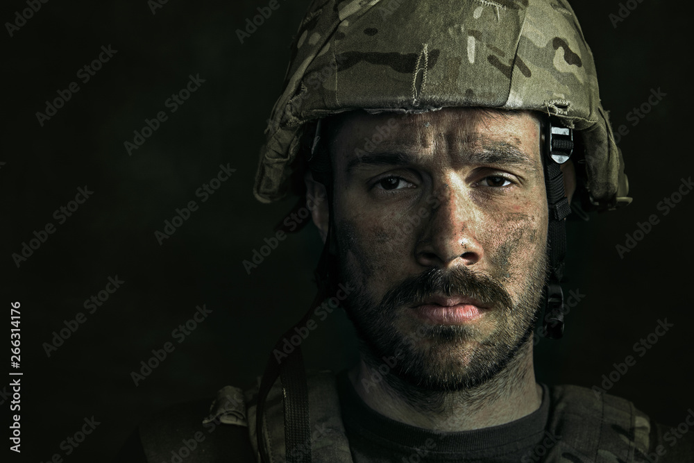 No feels and emotions. Close up portrait of young male soldier. Man in military uniform on the war. Depressed and having problems with mental health and emotions, PTSD, rehabilitation. No feels and emotions. Close up portrait of young male soldier. Man in military uniform on the war. Depressed and having problems with mental health and emotions, PTSD, rehabilitation.