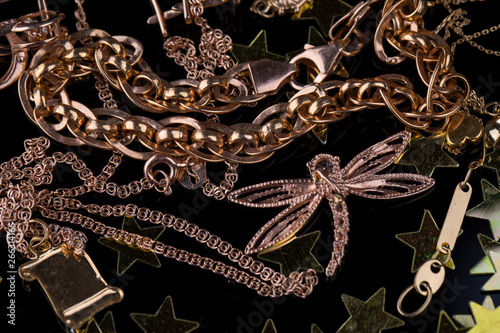Abstract gold chain, braclet and jewerly on a dark background