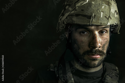 Doesn't wait for real life. Close up portrait of young male soldier. Man in military uniform on the war. Depressed and having problems with mental health and emotions, PTSD, rehabilitation.