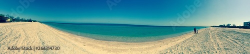 Walk along the sandy beach close to the serene sea