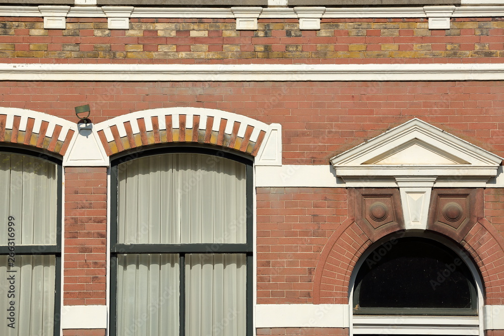 Close-up on a historical facade with carvings, located along Oude Delft Canal, Delft, Netherlands Close-up on a historical facade with carvings, located along Oude Delft Canal, Delft, Netherlands