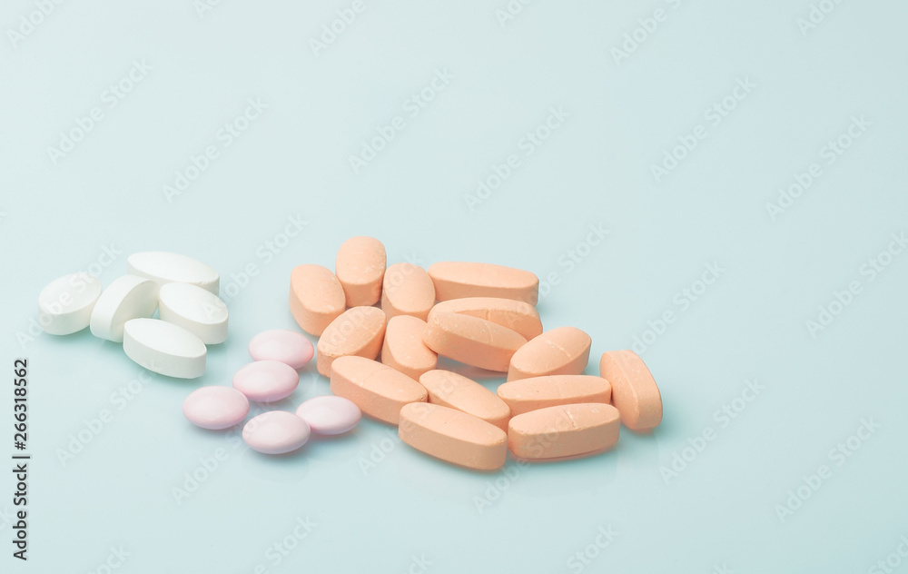 medical red and white pills and capsules with medicine are on a blue background medical red and white pills and capsules with medicine are on a blue background