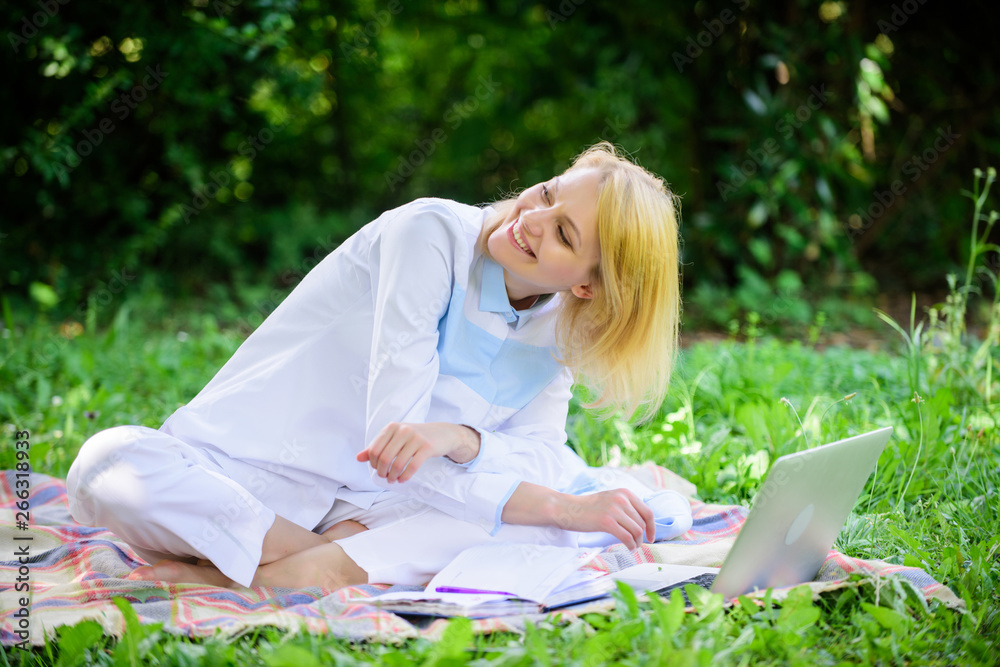 Woman with laptop or notebook sit on rug green grass meadow. Online business ideas concept. Business picnic concept. Steps to start freelancing business. Business lady freelancer work outdoors Woman with laptop or notebook sit on rug green grass meadow. Online business ideas concept. Business picnic concept. Steps to start freelancing business. Business lady freelancer work outdoors