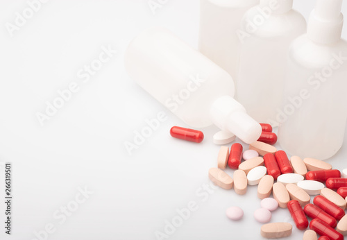 medical red and white pills and capsules with medicine are on a white background
