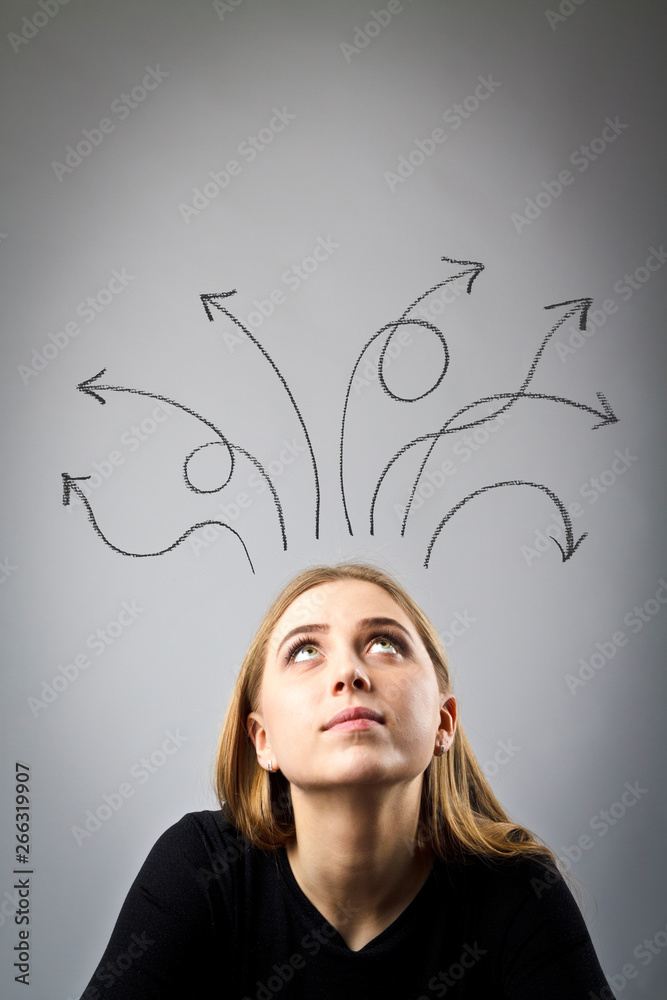 Frustrated young woman in thoughts. Arrows over her head. Frustrated young woman in thoughts. Arrows over her head.