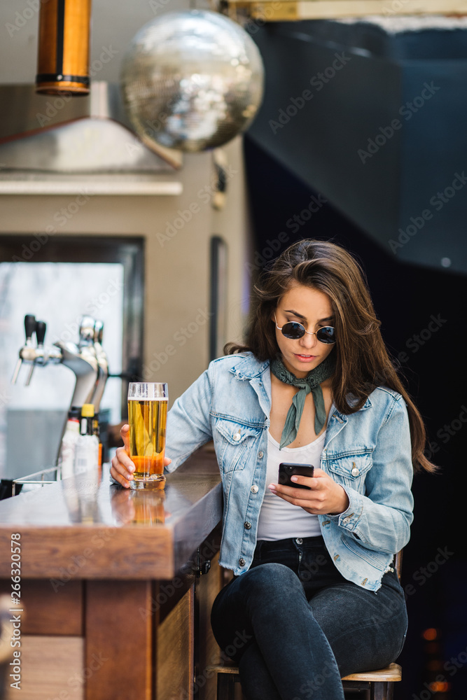 Beautiful woman having beer at the bar. Beautiful woman having beer at the bar.