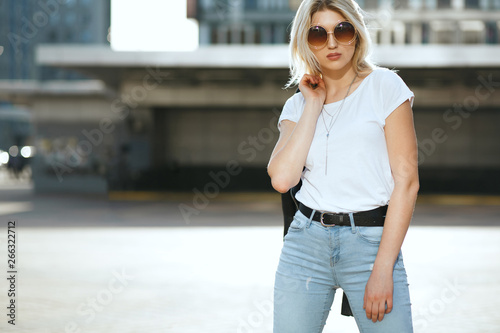 Lifestyle portrait of young splendid woman wearing vintage sunglasses and fashionable outfit. Empty space