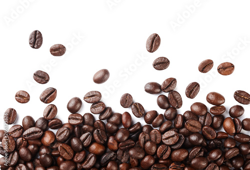 Falling roasted coffee beans isolated on white background.