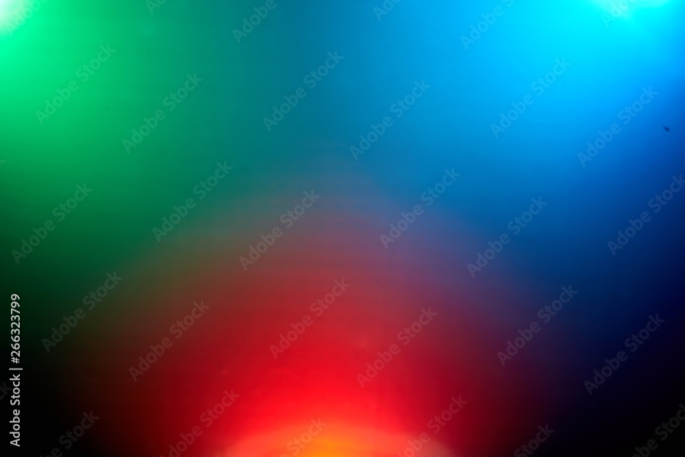 background of multicolored rays of light against a dark background