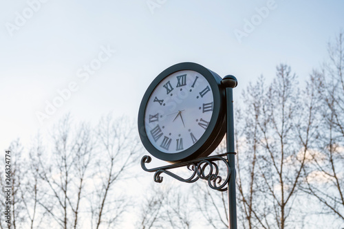 retro clock outdoor in the sky, time seven hours