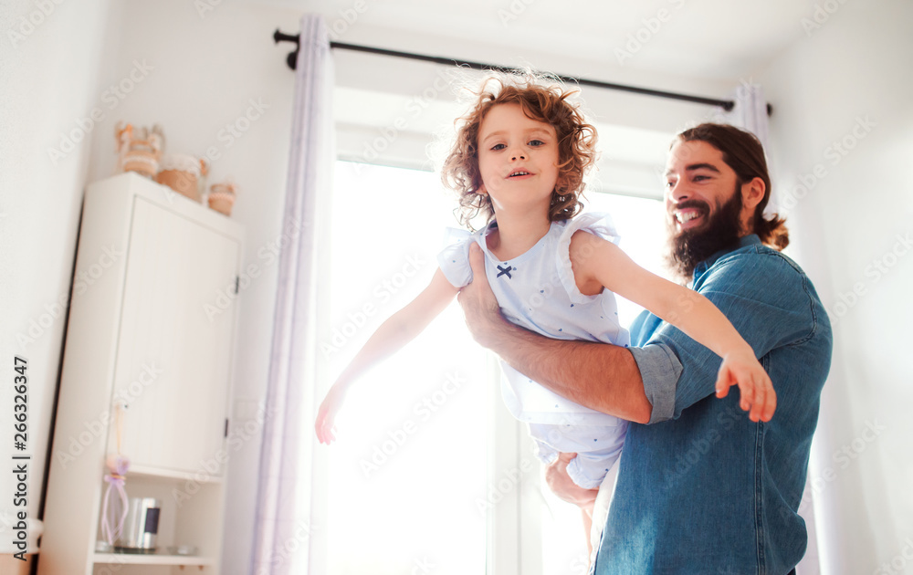Fototapeta premium Small girl with young father in bathroom at home, having fun.
