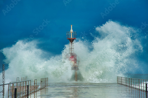 Wave breaking on the lighthouse.