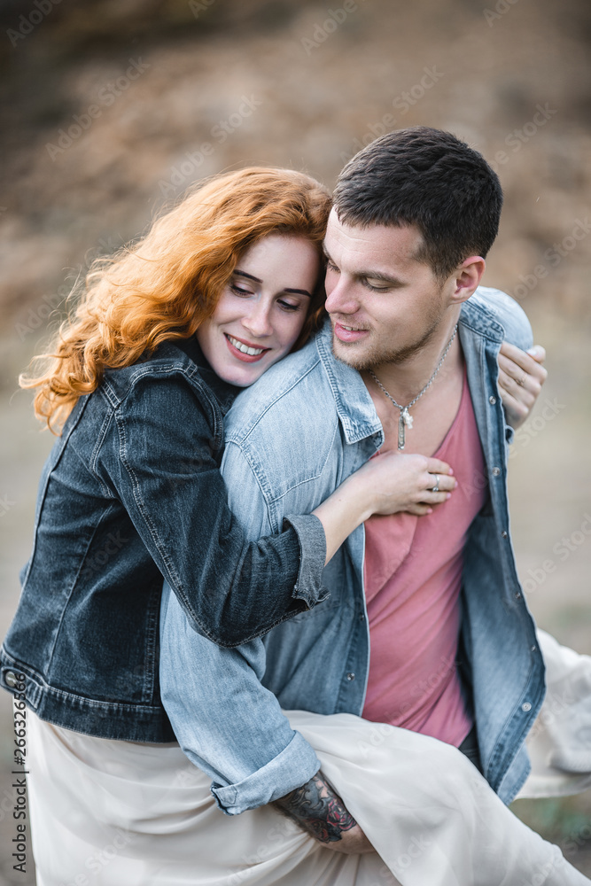 Fototapeta premium Portrait of a happy young couple enjoying a day in the park together