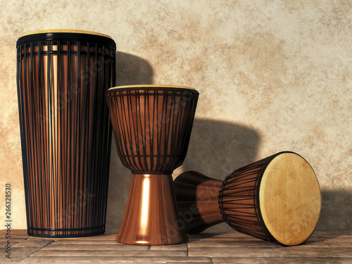 Several djembe and djun drums sit on a floor by a stucco wall.  These musical instruments are forms of African tribal drums. 3D Rendering photo