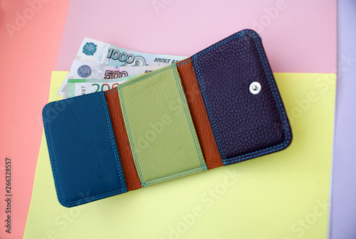 Purse with money on a colored background. photo