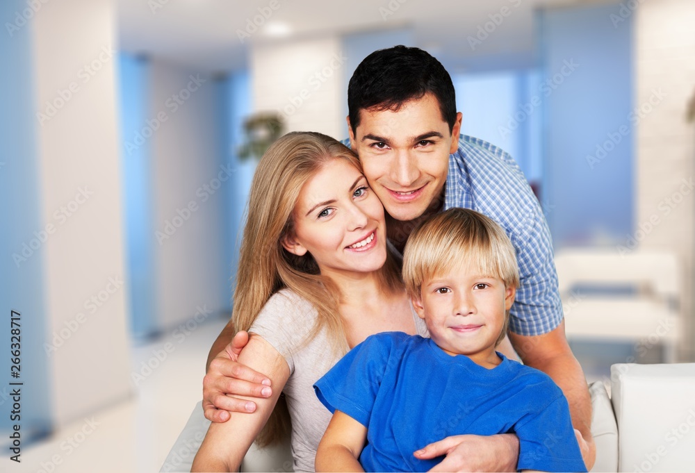 Beautiful smiling family in room on couch Beautiful smiling family in room on couch