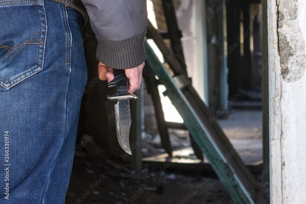 A man with a knife in his hand in an abandoned building is ready to kill A man with a knife in his hand in an abandoned building is ready to kill
