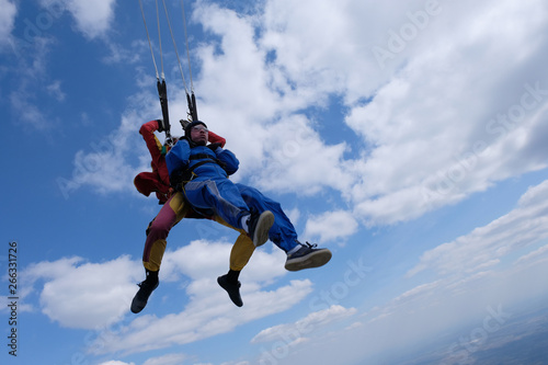 Skydiving. Tandem jump. Happy passenger and his instructor.